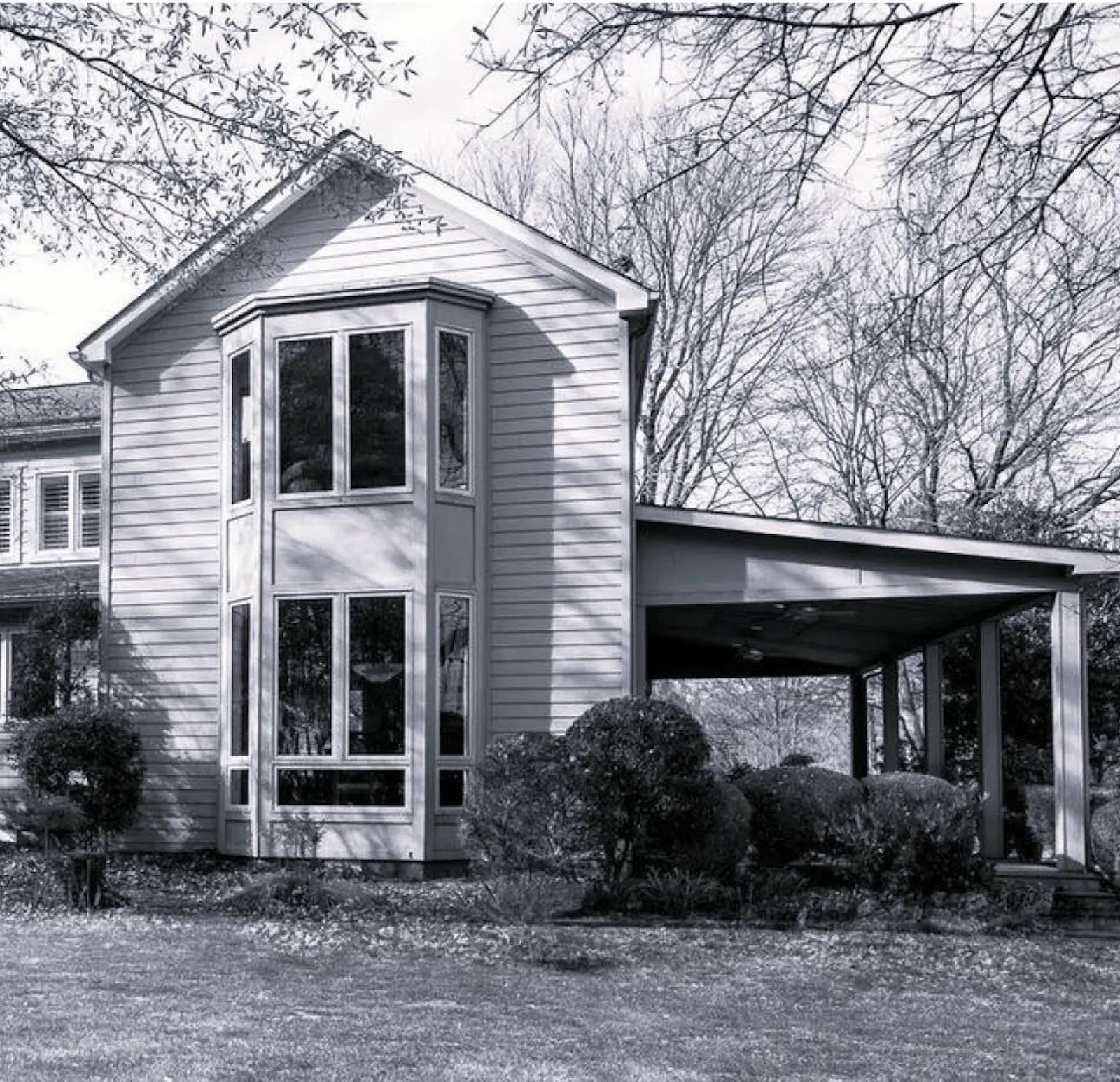 A before and after comparison of the farmhouse's rear facade