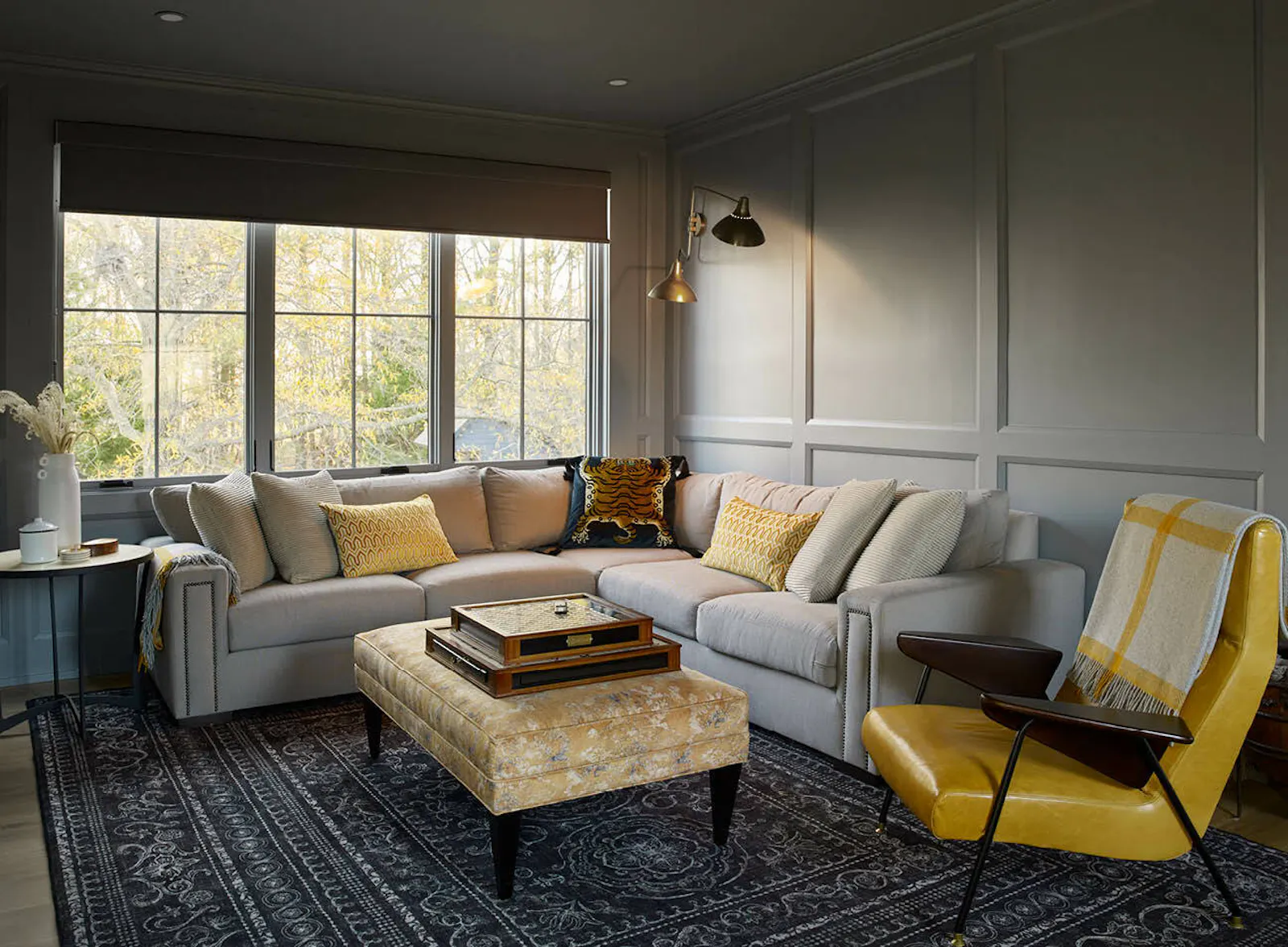A sitting room with board-and-batten cladding and a bold, updated primary stair