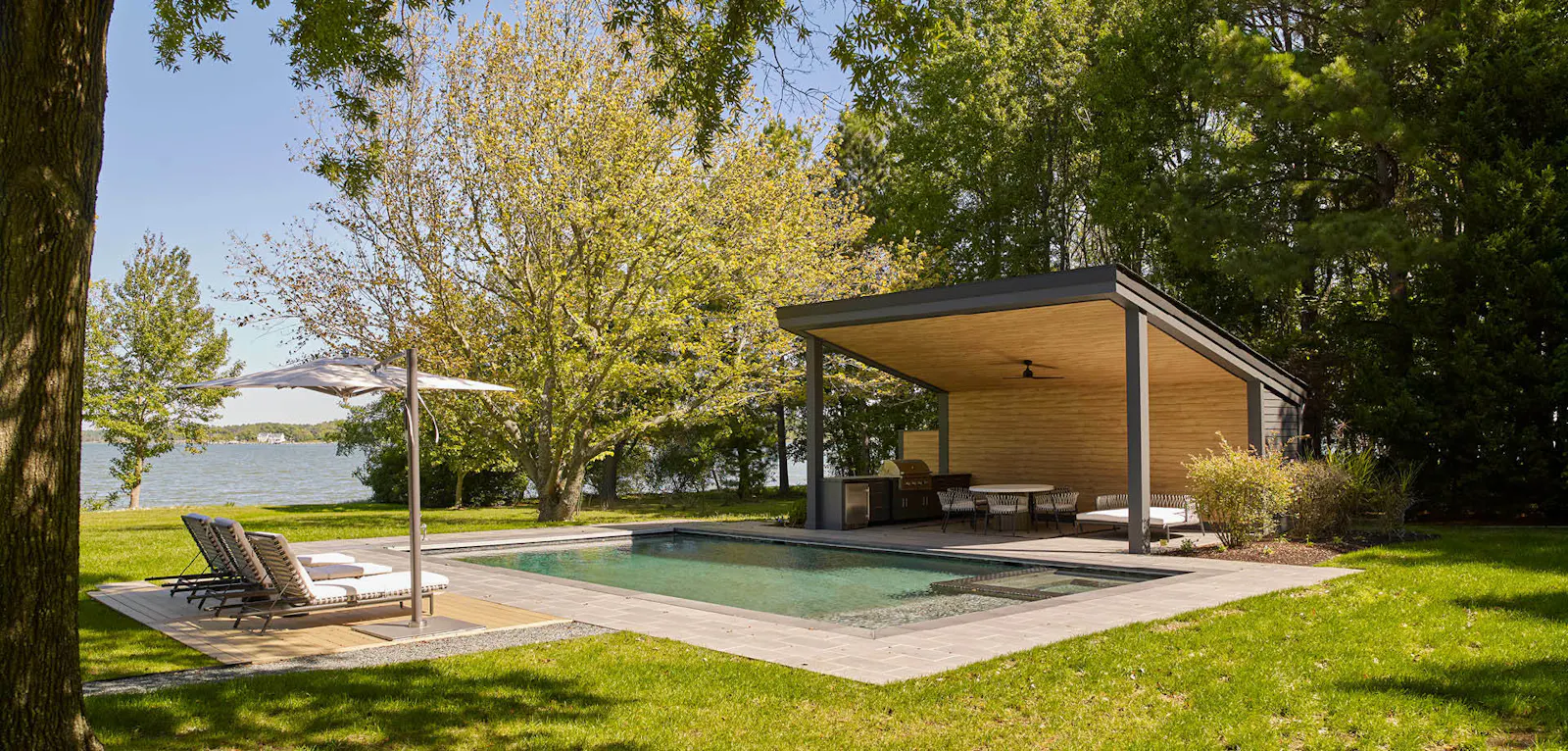 The pool pavilion, which features an outdoor kitchen, dining area, shower and storage