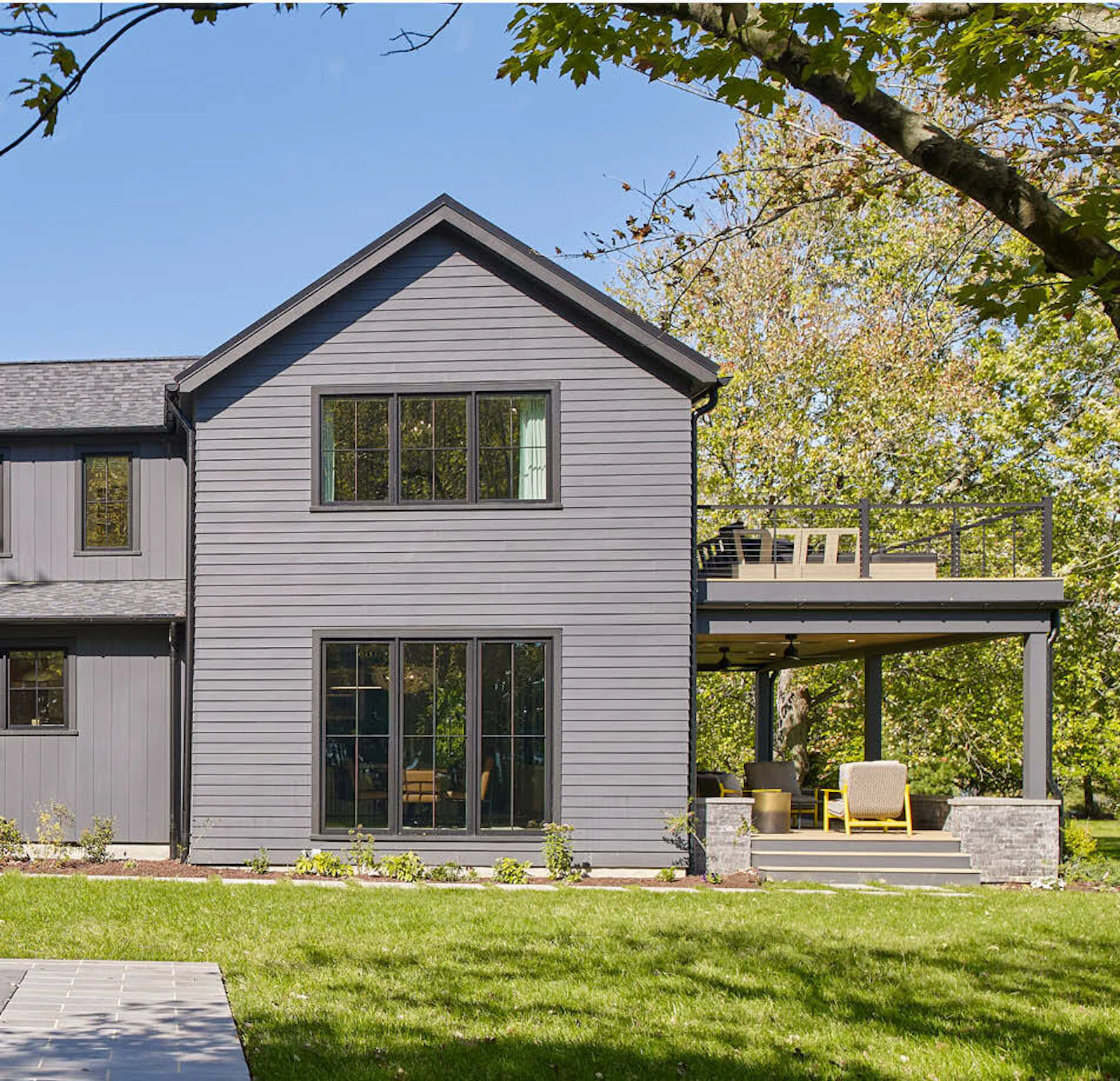 A before and after comparison of the farmhouse's rear facade