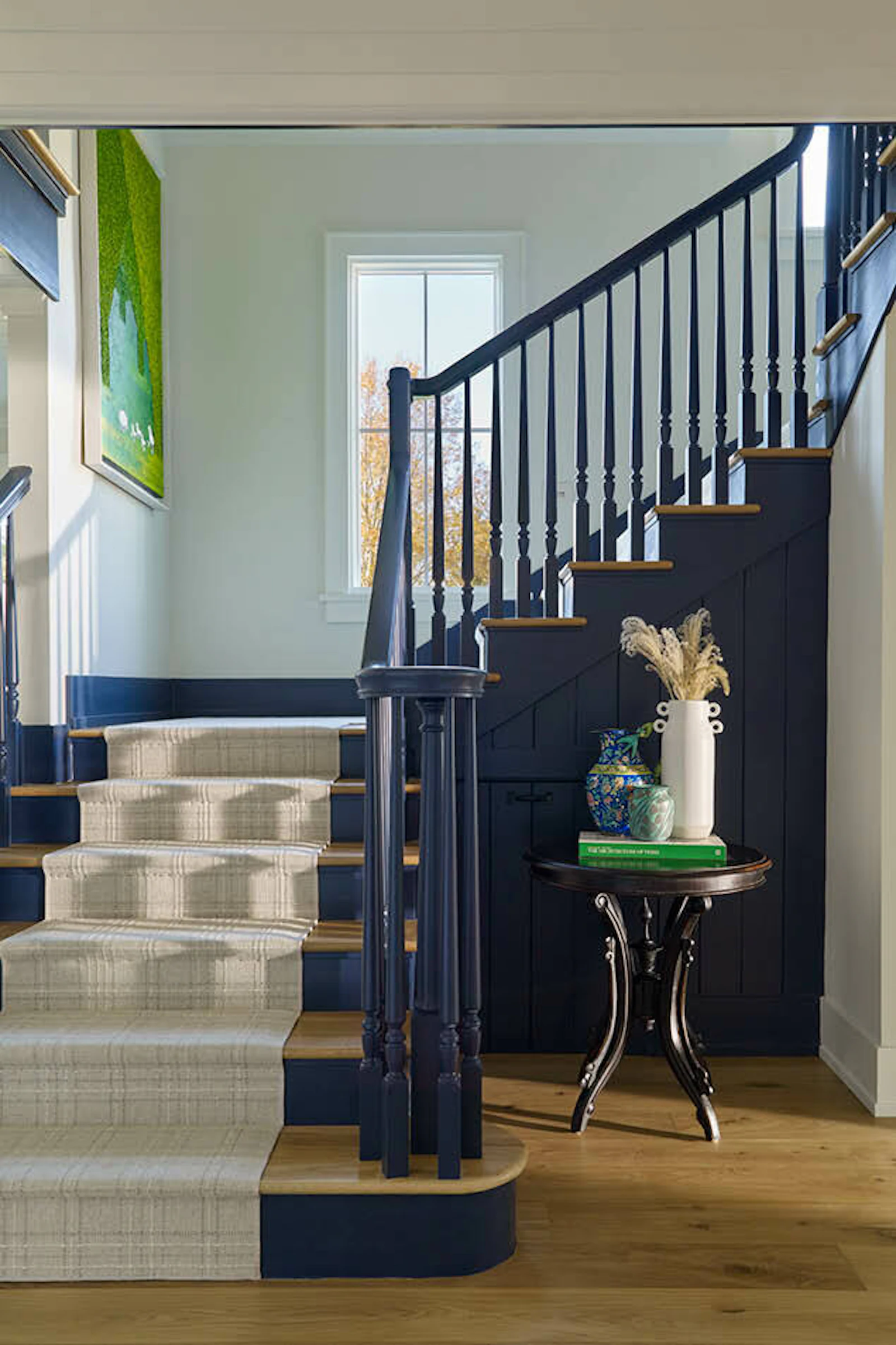 A sitting room with board-and-batten cladding and a bold, updated primary stair