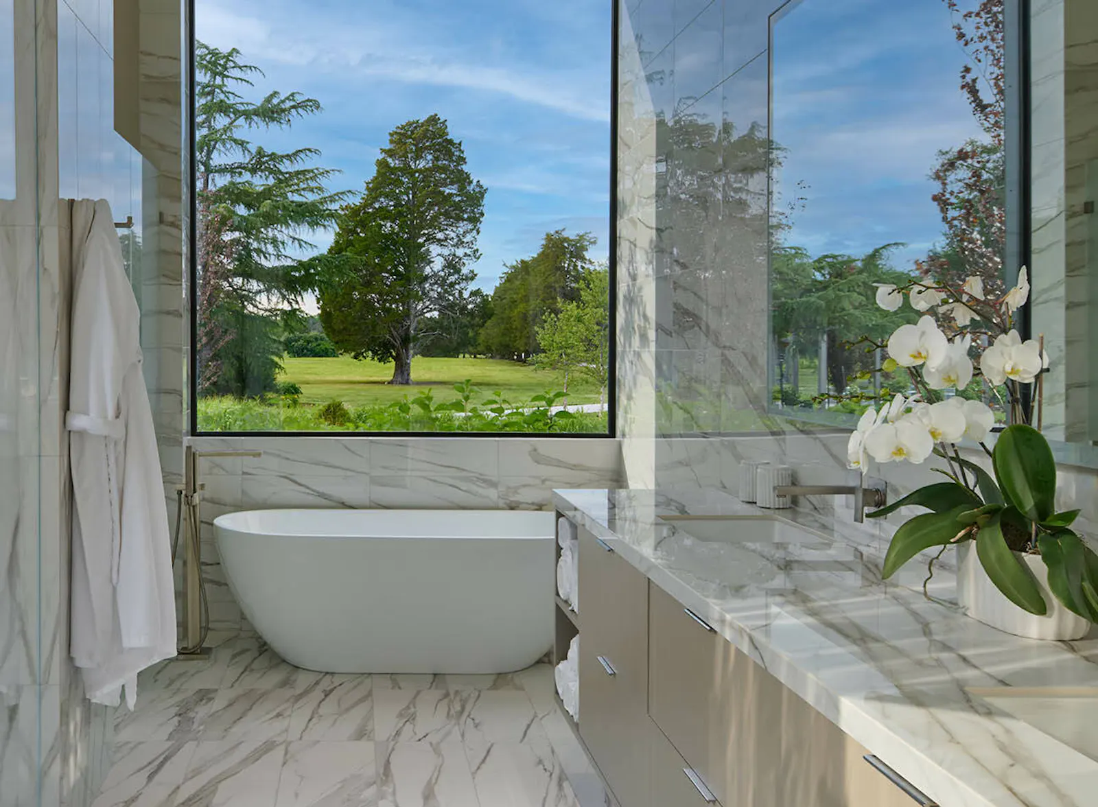 A luxurious main suite bathroom also includes a walkout to an outdoor shower. 