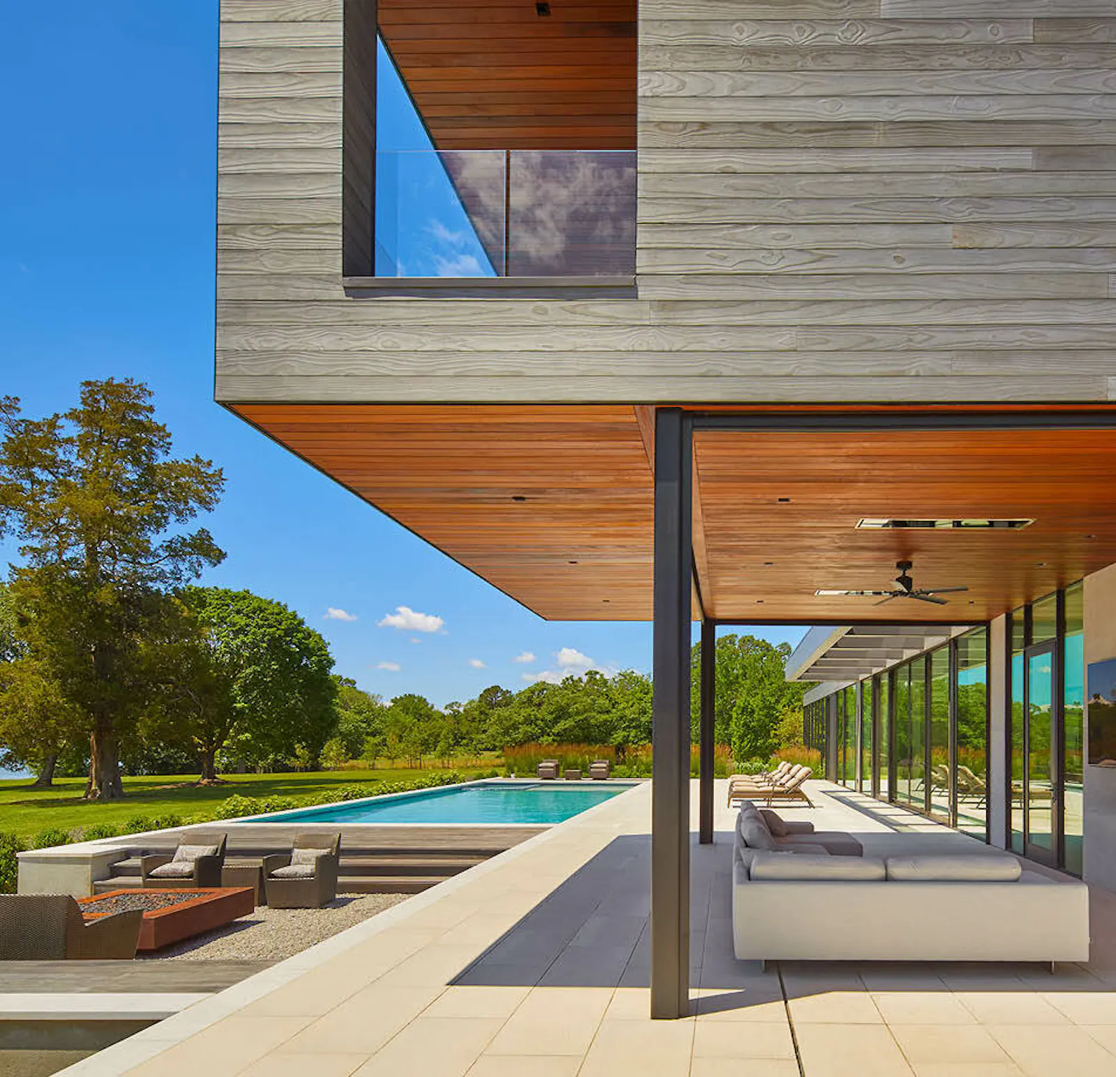 A cantilevered sitting room on the second floor provides shading for the outdoor deck. 
