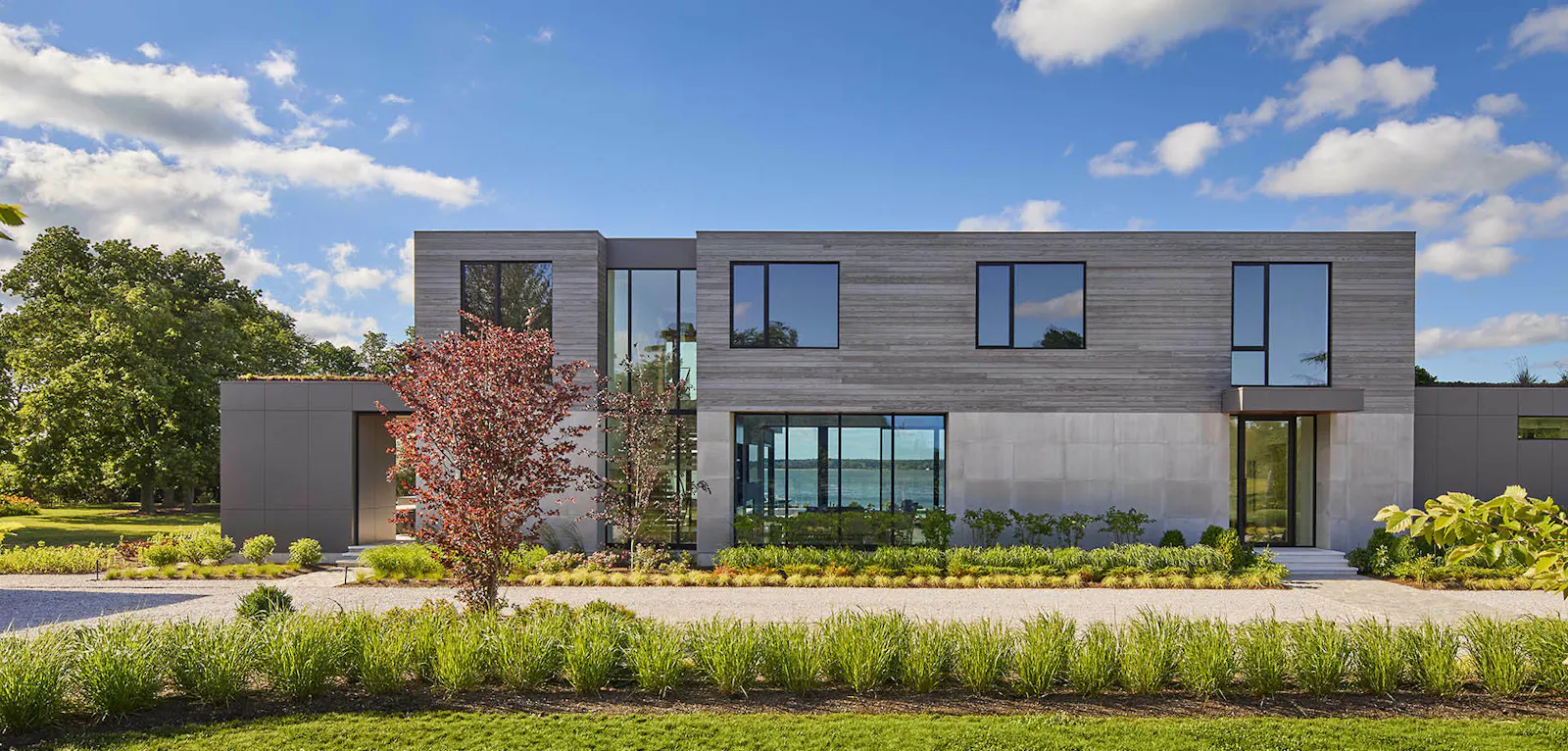 The front facade of the building, which includes wooden, glass, and concrete accents. 