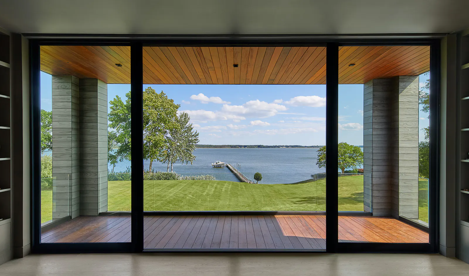 A sitting room provides an observation area overlooking the pool, firepit, and river. 