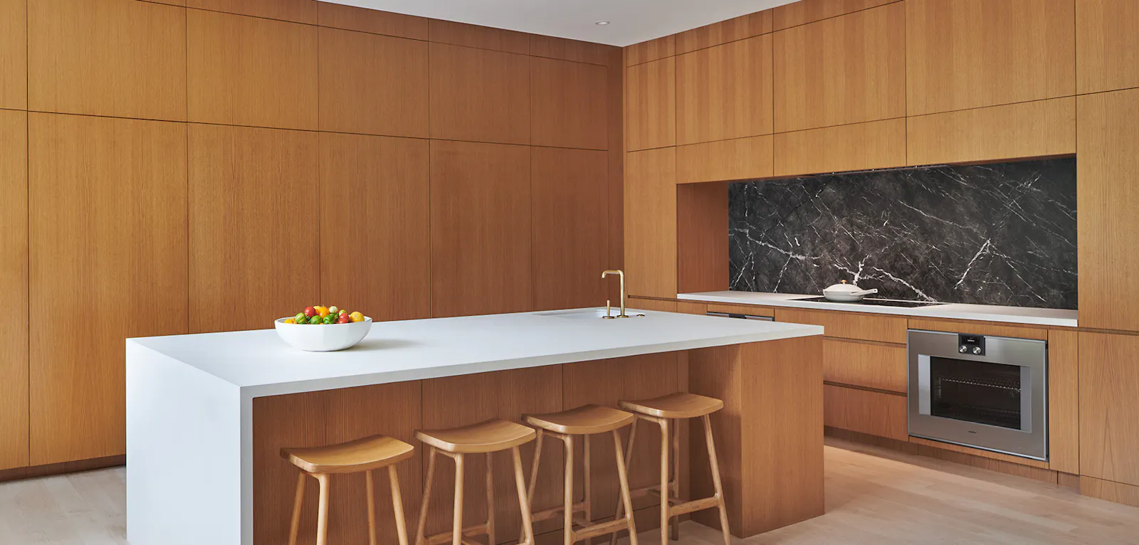 Maple wood conceals kitchen appliances for a warm, calming feel. 