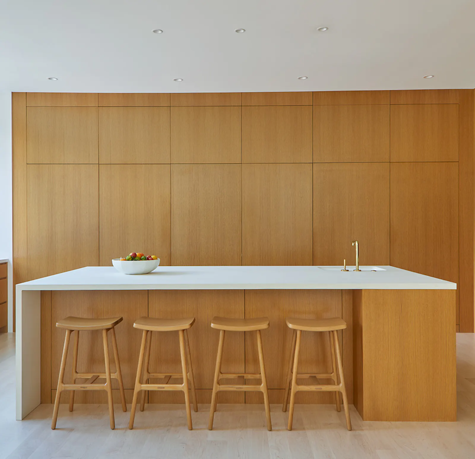 Concealed wooden systems hide all kitchen appliances and storage. 