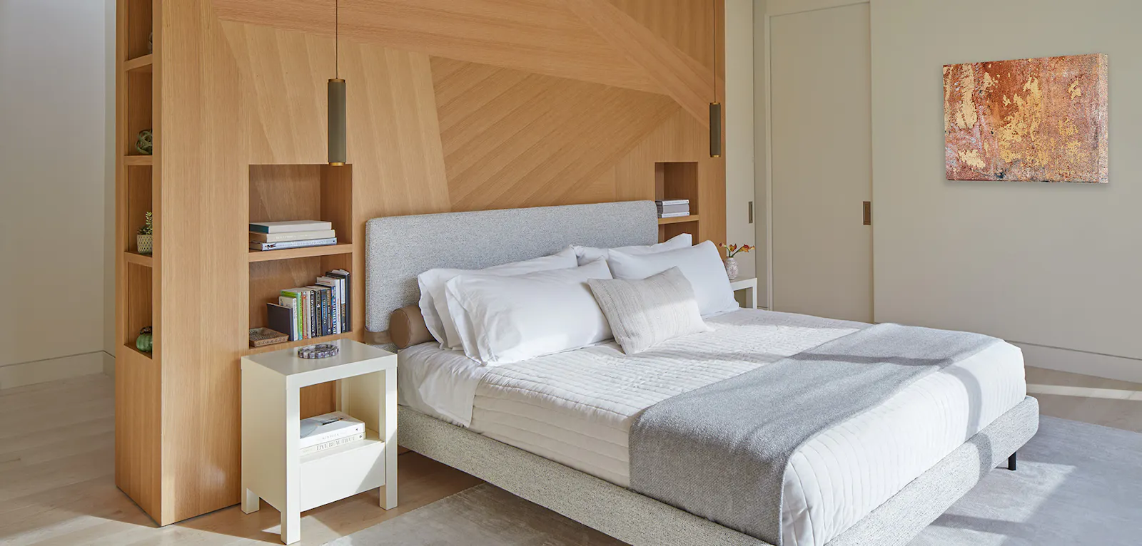 A bedroom with built-in maple wood storage 