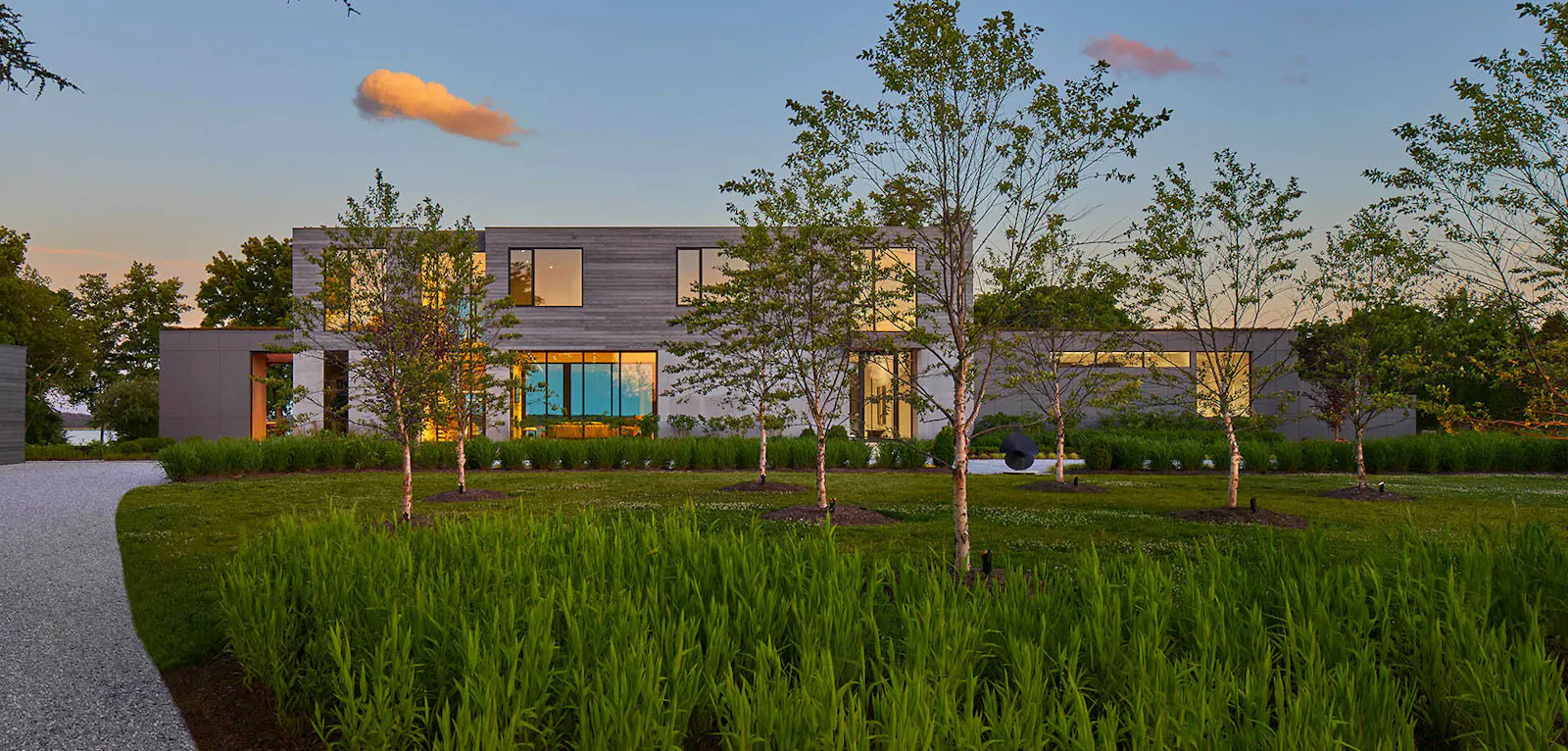 The contemporary riverfront home is designed to blend with its natural surroundings. 