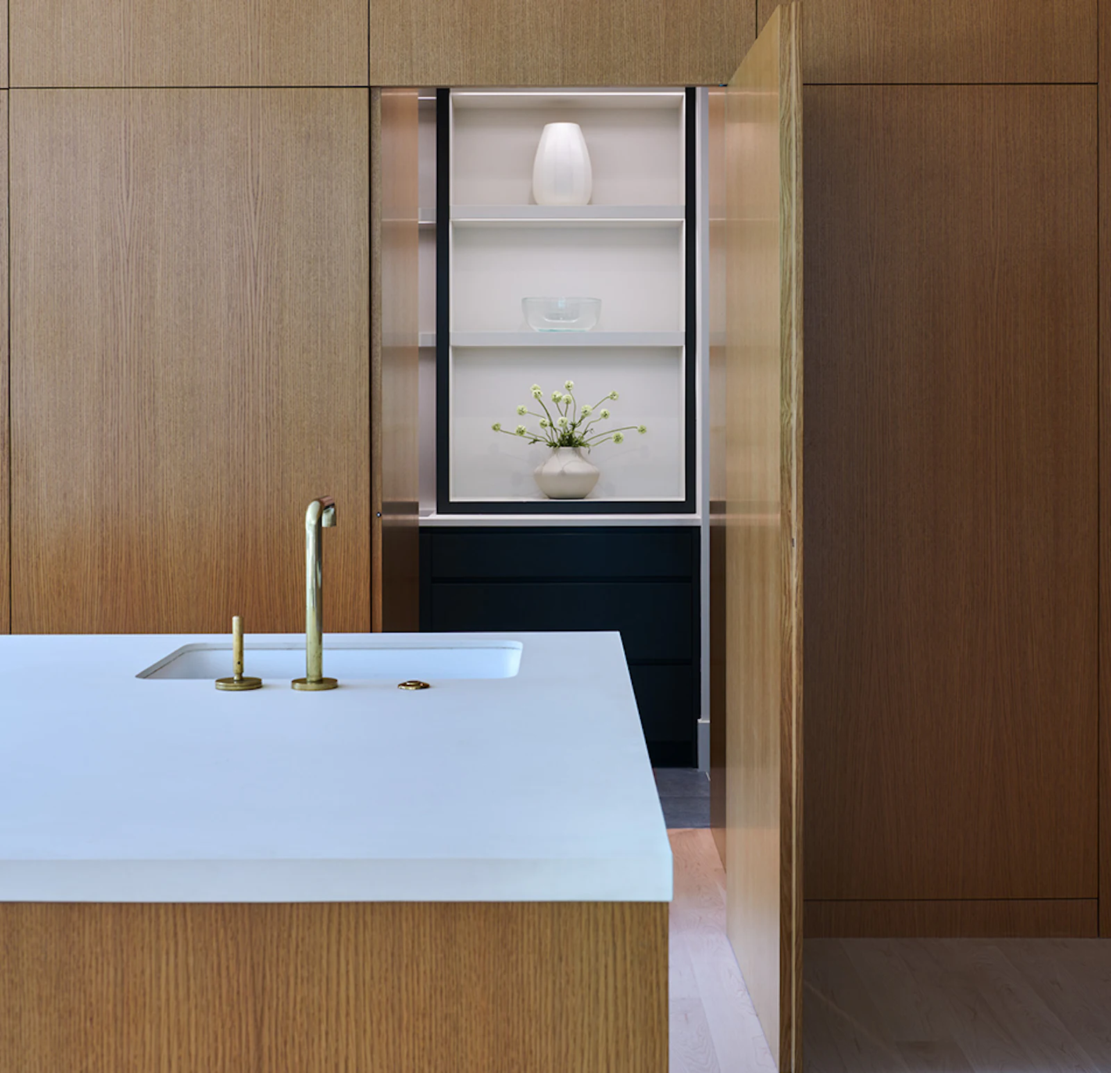 The kitchen features extensive maple cabinetry, hidden storage, and vast views to the outdoors. 