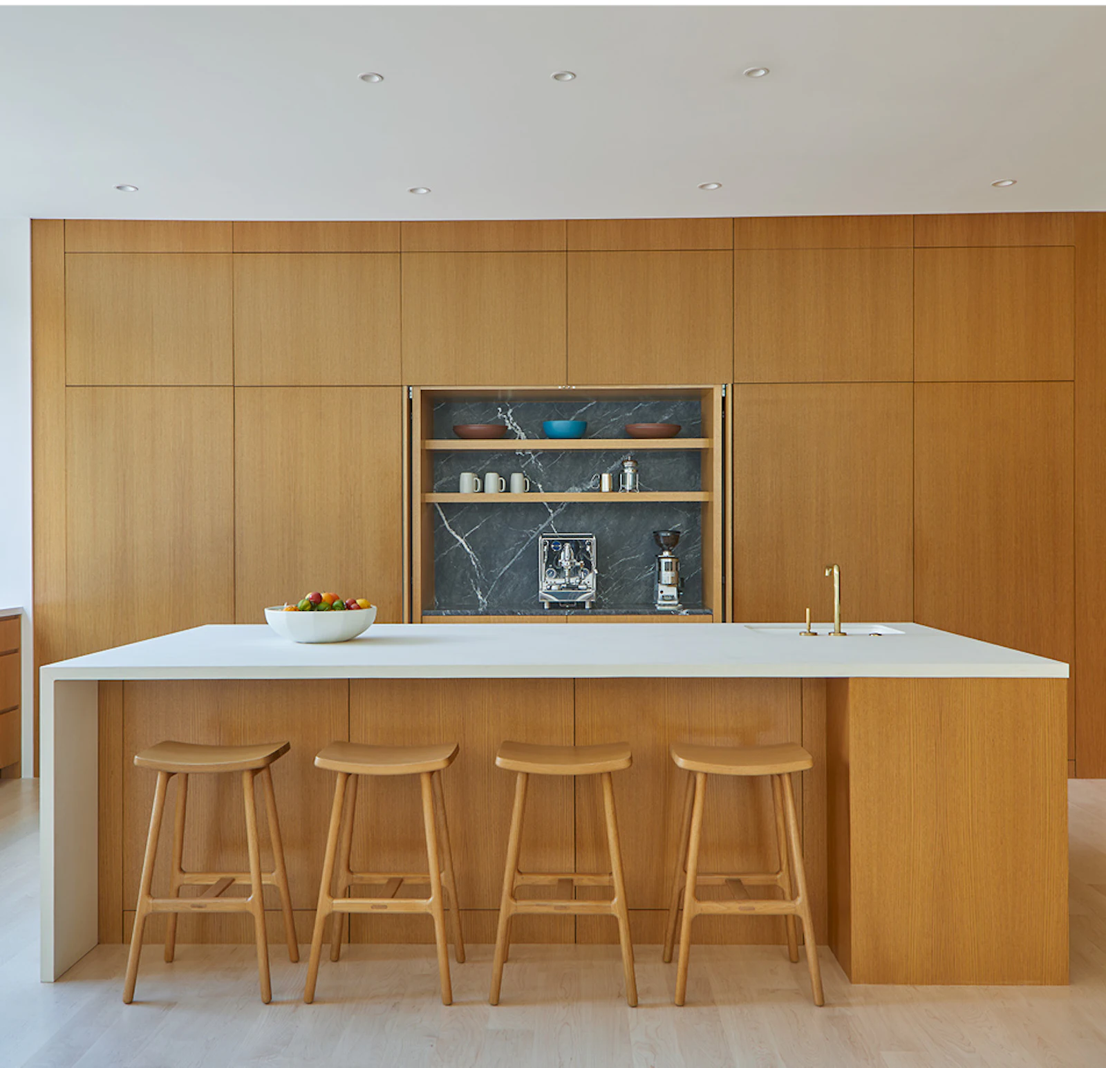 Concealed wooden systems hide all kitchen appliances and storage. 
