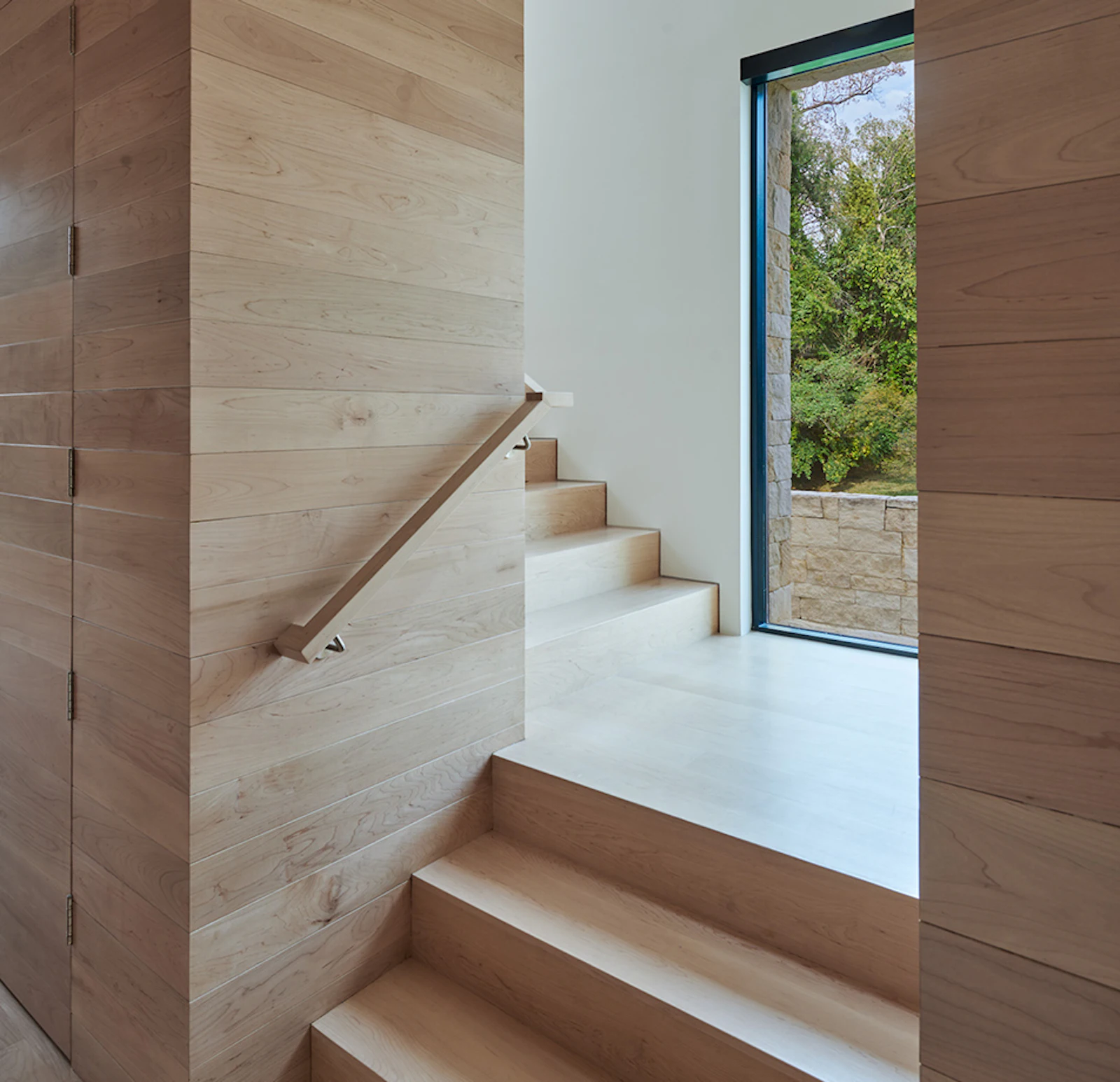 A maple-enclosed corridor serves as a rotating gallery. 
